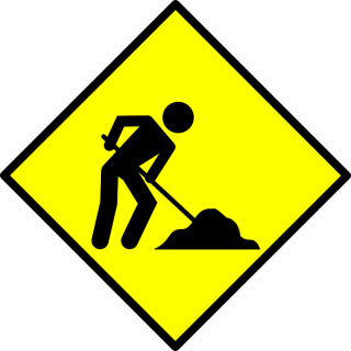 Yelow sign with man shoveling